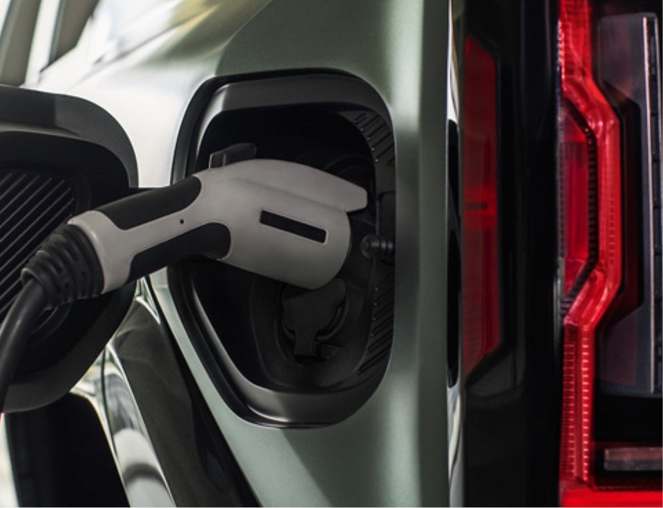 Close up of charging port with charger plugged in on a GMC Hummer EV SUV - Van Buren GMC in Garden City Park NY