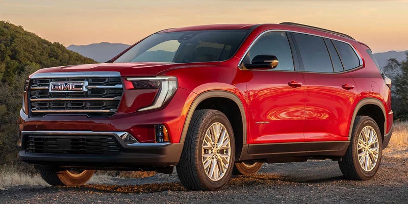 2026 GMC Acadia trim lineup including Elevation AT4 Denali and Denali Ultimate shown at dealership in Garden City Park NY