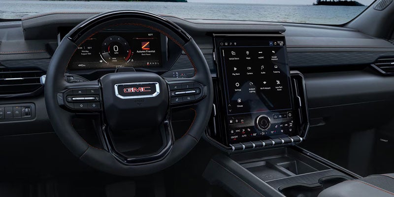 2026 GMC Acadia interior steering wheel with driver controls and digital display in Garden City Park NY