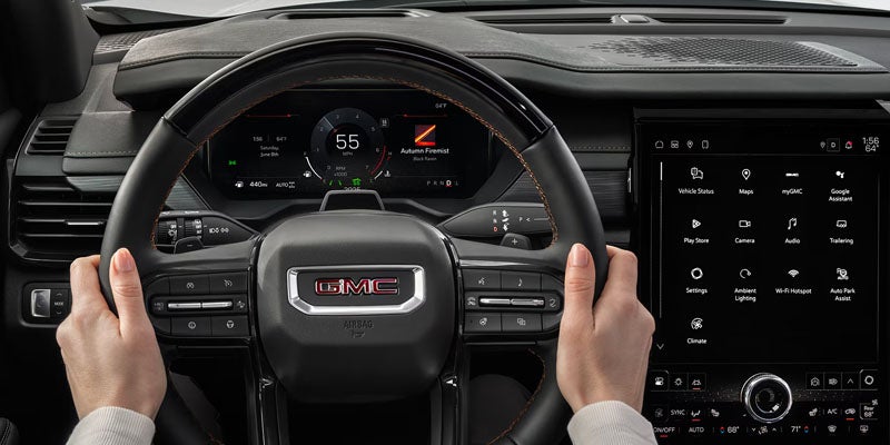 2026 GMC Acadia in Garden City Park NY showing advanced safety features including lane keep assist and automatic emergency braking on Long Island roads