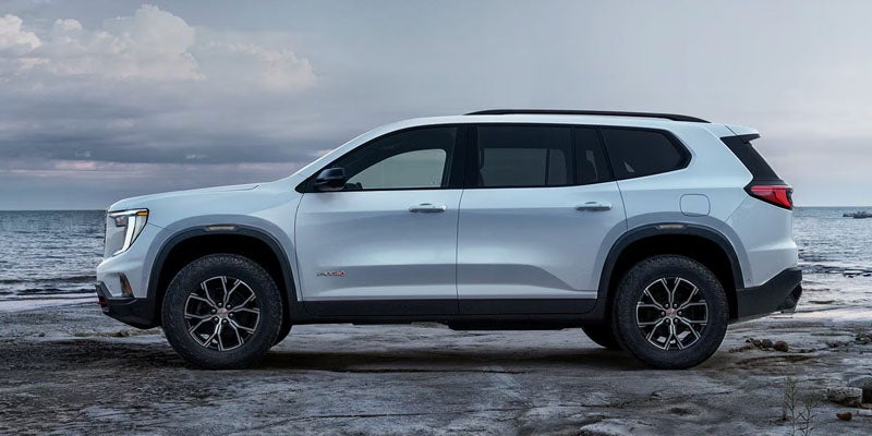 Side profile view of 2026 GMC Acadia in Garden City Park NY parked near Long Island suburban streets and parkways