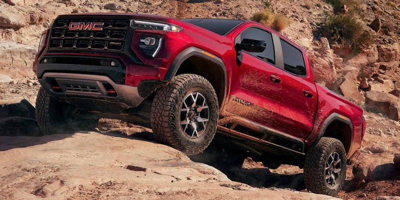 2026 GMC Canyon driving near Garden City Park NY on Long Island parkways showing 2.7L TurboMax engine performance and towing capability