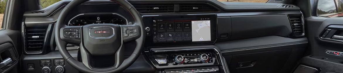 2026 GMC Sierra 1500 infotainment system in Garden City Park, NY featuring a 13.4-inch touchscreen with Google built-in services, Apple CarPlay®, and Android Auto® for seamless connectivity and media control.