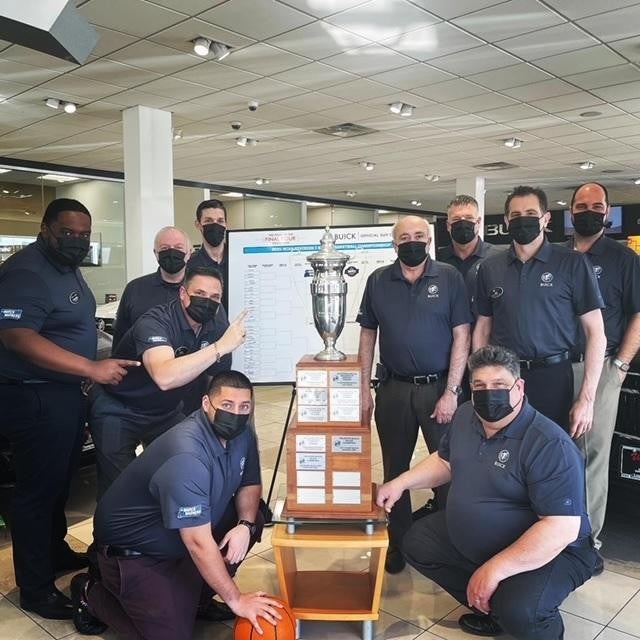 Van Buren Staff members with a trophy